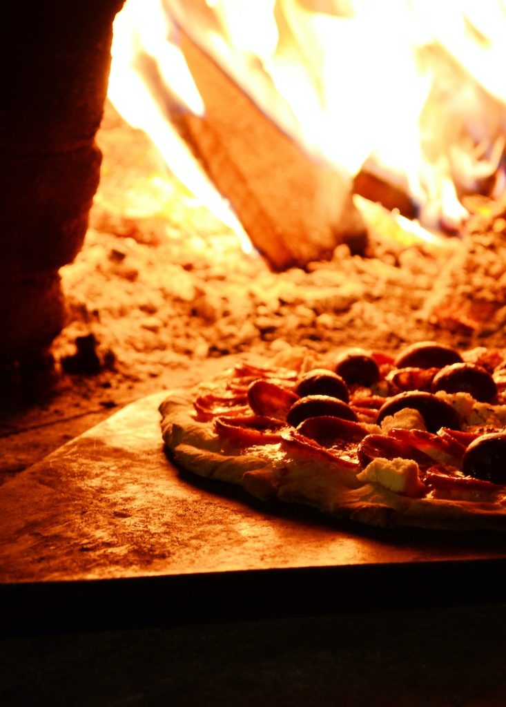 Close-up Photo of Pizza Near Bonfire